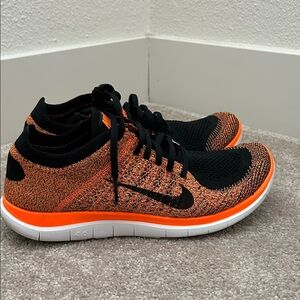 Nike Black & Orange Flyknit Low-Top Sneakers
